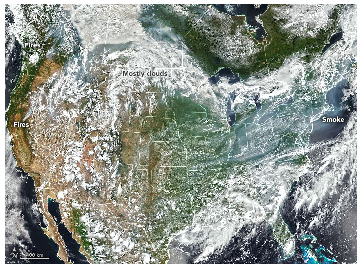 A visible satellite image of the middle latitudes on the northern western hemisphere on July 20, 2021. Smoke from western forest fires can be seen among clouds near the US-Canadian border in the west and dominates the sky over the Midwest in the Mid-Atlantic states.