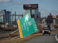 Highway sign knocked over by the wind